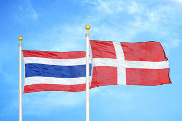 Thailand and Denmark two flags on flagpoles and blue sky