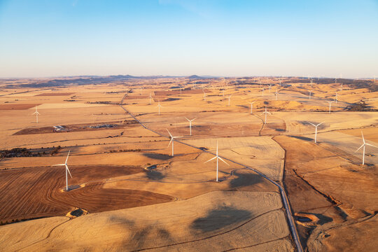 aerial view of wind turbines in farmland
