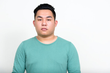 Portrait of young handsome overweight Asian man