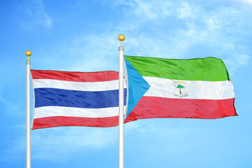 Thailand and Equatorial Guinea two flags on flagpoles and blue sky