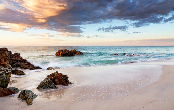 Fototapeta rocks and beach at sunrise
