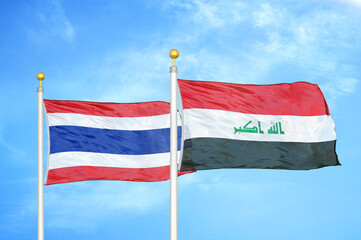 Thailand and Iraq two flags on flagpoles and blue sky