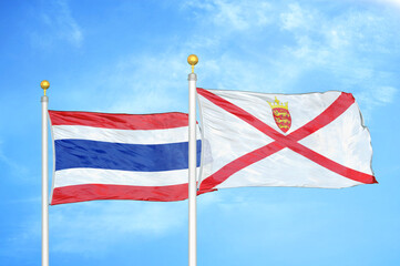 Thailand and Jersey two flags on flagpoles and blue sky