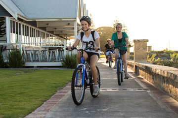Teen girls riding bikes on dual use path at Busselton