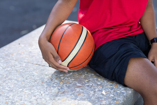 basketball being held by player on sidelines
