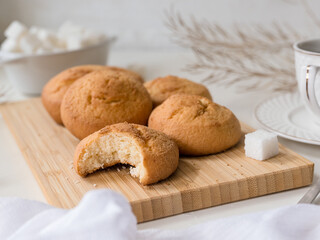 bite off a piece of biscuit cookie, a fragment of a still life with pastries, a cup and sugar