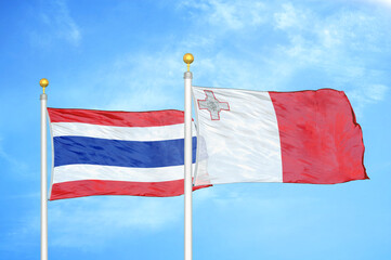 Thailand and Malta two flags on flagpoles and blue sky