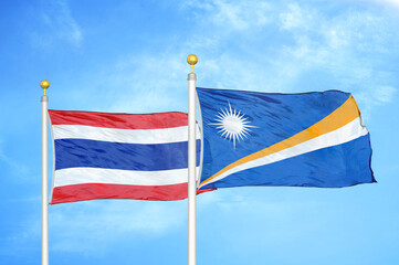 Thailand and Marshall Islands two flags on flagpoles and blue sky