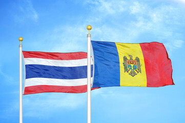 Thailand and Moldova two flags on flagpoles and blue sky