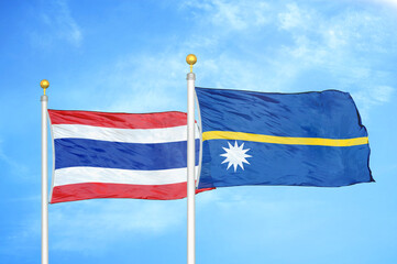 Thailand and Nauru two flags on flagpoles and blue sky