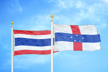 Thailand and Netherlands Antilles two flags on flagpoles and blue sky