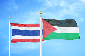 Thailand and Palestine two flags on flagpoles and blue sky