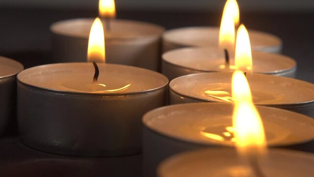 Blowing off a row of tealights, slow motion