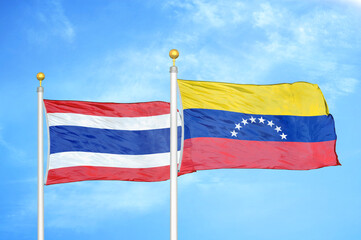 Thailand and Venezuela two flags on flagpoles and blue sky
