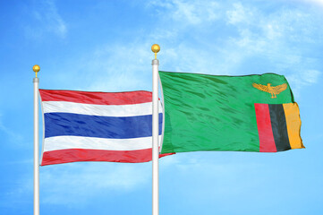 Thailand and Zambia two flags on flagpoles and blue sky