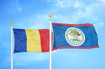 Romania and Belize two flags on flagpoles and blue sky