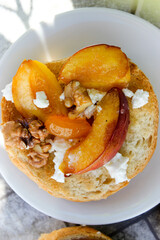 al fresco Breakfast of grilled bread rolls with goat fat, fruit, nuts, orange juice and coffee