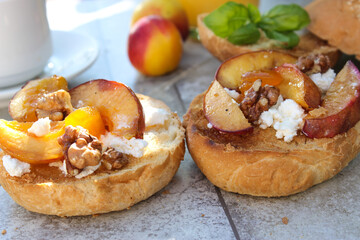 al fresco Breakfast of grilled bread rolls with goat fat, fruit, nuts, orange juice and coffee