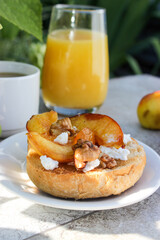 al fresco Breakfast of grilled bread rolls with goat fat, fruit, nuts, orange juice and coffee