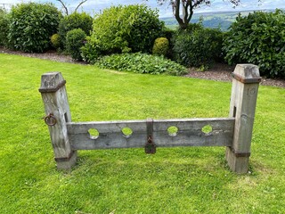 Old wooden stocks, transferred in 2016 to a small garden in, Sowerby Bridge, Yorkshire, UK