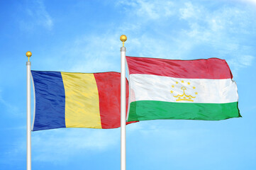 Romania and Tajikistan two flags on flagpoles and blue sky