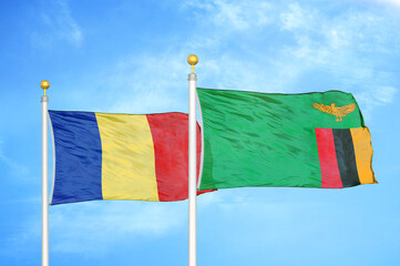 Romania and Zambia two flags on flagpoles and blue sky