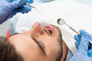 Man having teeth examined at dentists