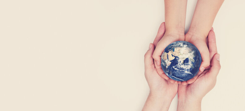 Earth globe in family hands. World safety. Elements of this image furnished by NASA