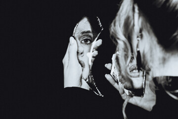 Retro girl and broken self-image mirror, black and white portrait