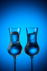 Strong alcoholic drink in frozen glasses with ice.