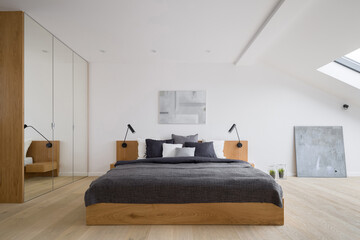 Modern attic bedroom with mirrored wardrobe