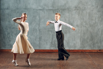 Young dancers boy and girl dancing in ballroom dance Samba.