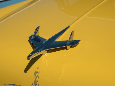 A jet plane hood ornament on a classic car