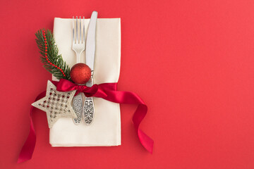 Christmas table setting on the red background. Top view. Copy space.