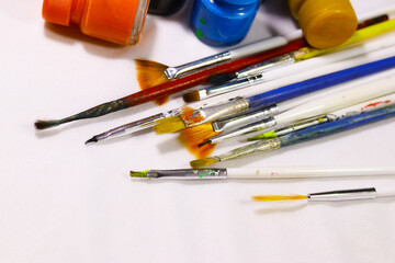Multicolored Paint Bottles with Painting Brushes, Selective focus, selective focus on subject.