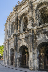 Fototapeta na wymiar Ancient Nimes Roman Amphitheatre. Nimes Arena (70 CE) - one of the best-preserved amphitheaters in the world. Nimes, Occitanie region of southern France.