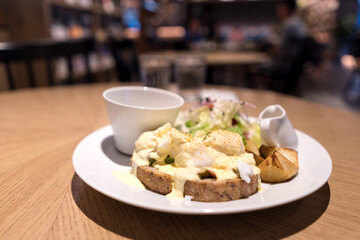Substantial breakfast with fried egg, salad, bread and coffee, top view