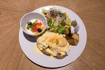 Substantial breakfast with fried egg, salad, bread and coffee, top view
