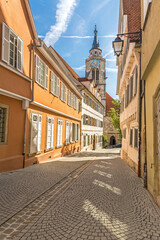 Historic buildings and church tower in a picturesque street in the old town of Tübingen in Southern Germany (vertical)