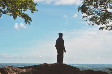 Man standing on a mountain, Silhouette of person in mountain.  