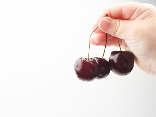 child holding a cherry