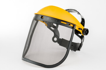 Yellow construction mask-grid on a wooden table on a white background.