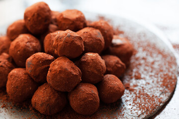 Chocolate candy truffle with cocoa and golden powder