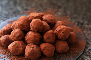 Chocolate candy truffle with cocoa and golden powder
