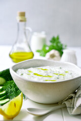 Obraz na płótnie Canvas Tzatziki - traditional greek yogurt sauce with cucumber, garlic and dill.