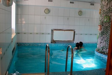 A person in a pool with blue water