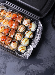 Set of sushi rolls in disposable containers. Food delivery service concept