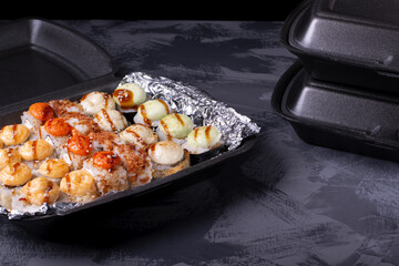 Set of sushi rolls in disposable containers. Food delivery service concept