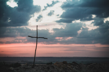 Old wooden cross on hill in sunny rays over. Orthodox christianity.