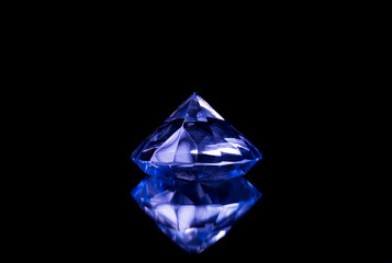 diamond with blue tones reflecting in a crystal on a black background